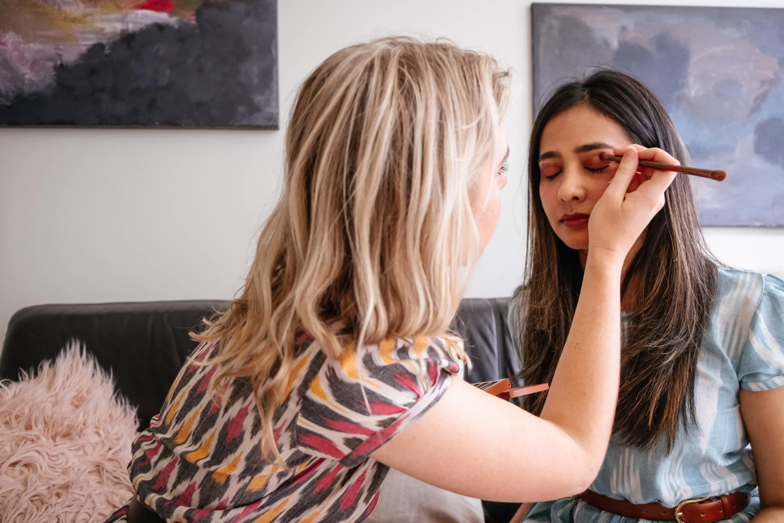 make up artist applying make up on other woman